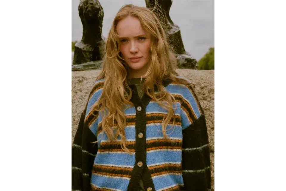 Portrait of a woman with blonde hair in a corn field. 