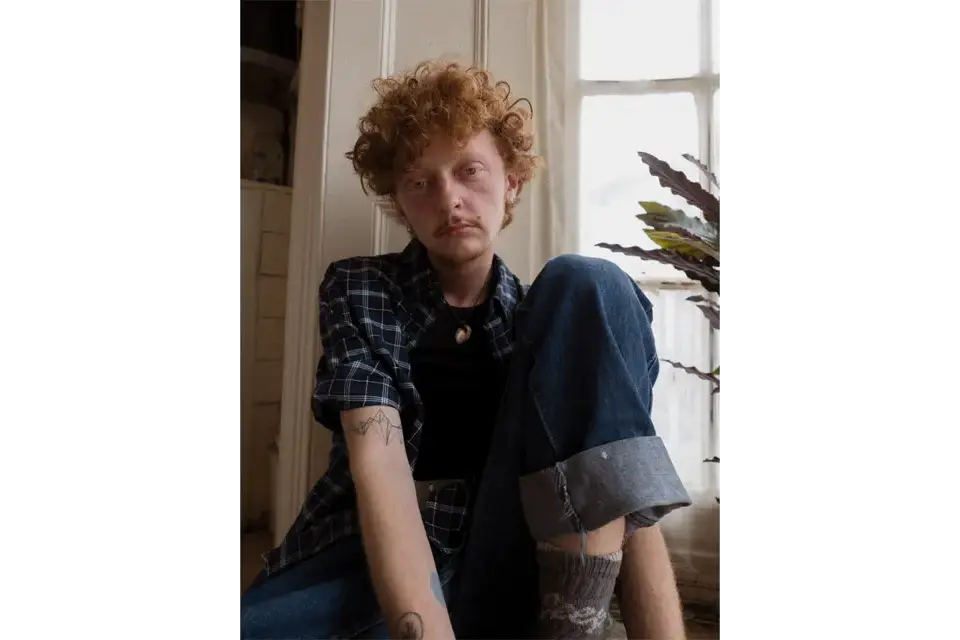 Portrait of a young man in his house. 