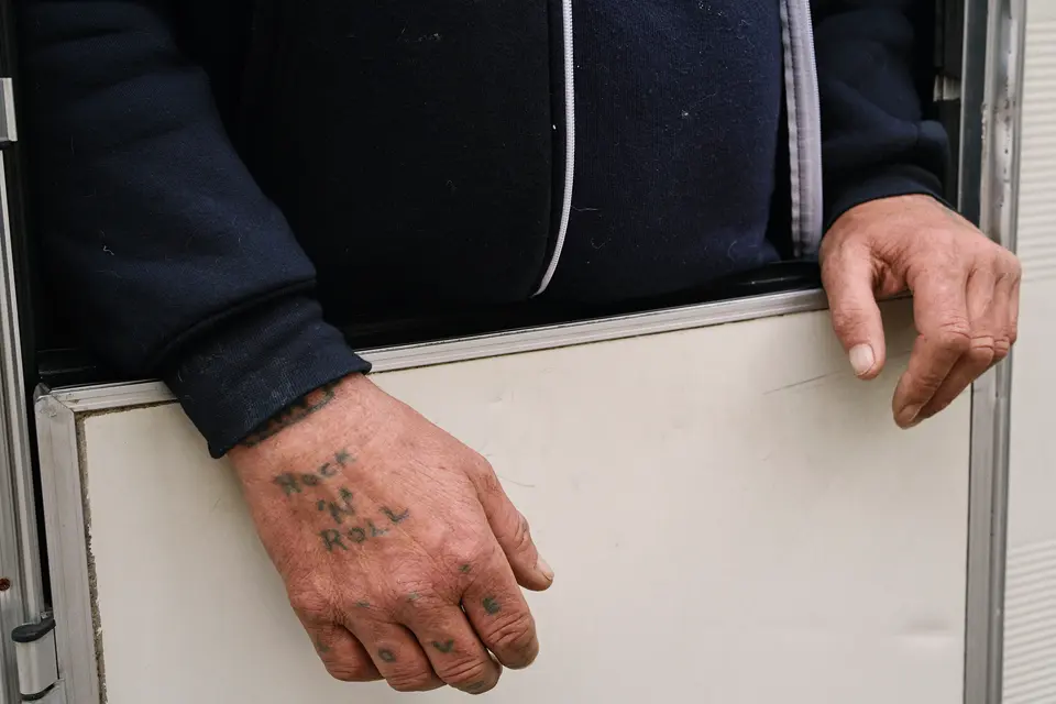 Portrait of a set of hands, showing a Rock and Roll tattoo