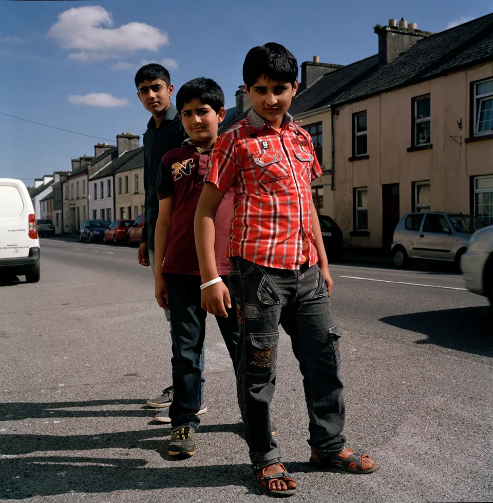 Photo of three boys on the road.