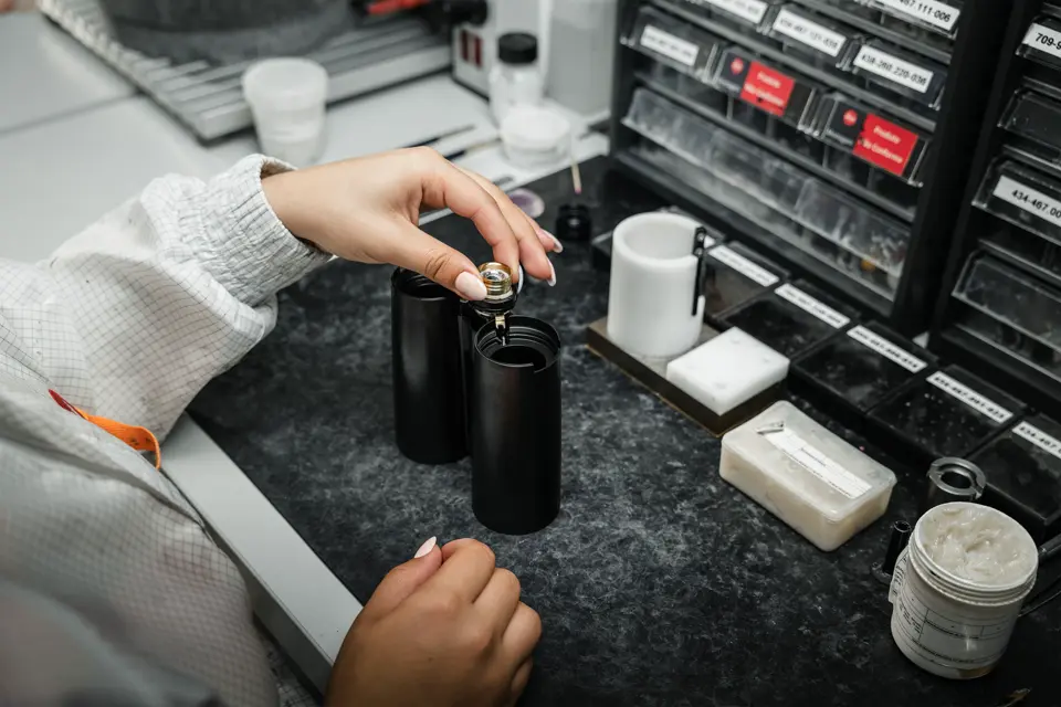 A worker working on the Leica binoculars