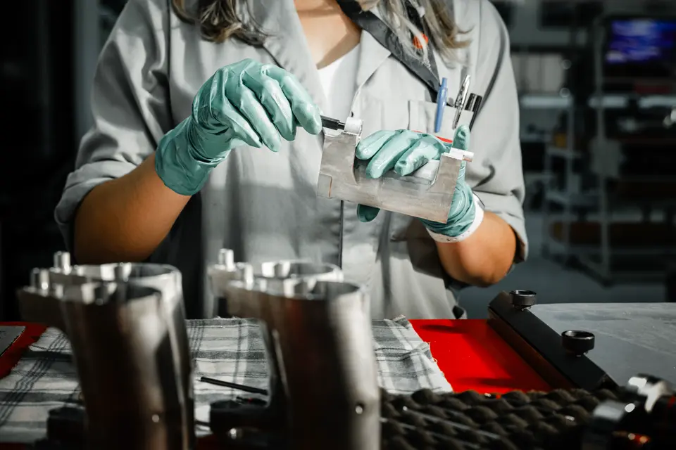 A worker making parts for the Leica binoculars