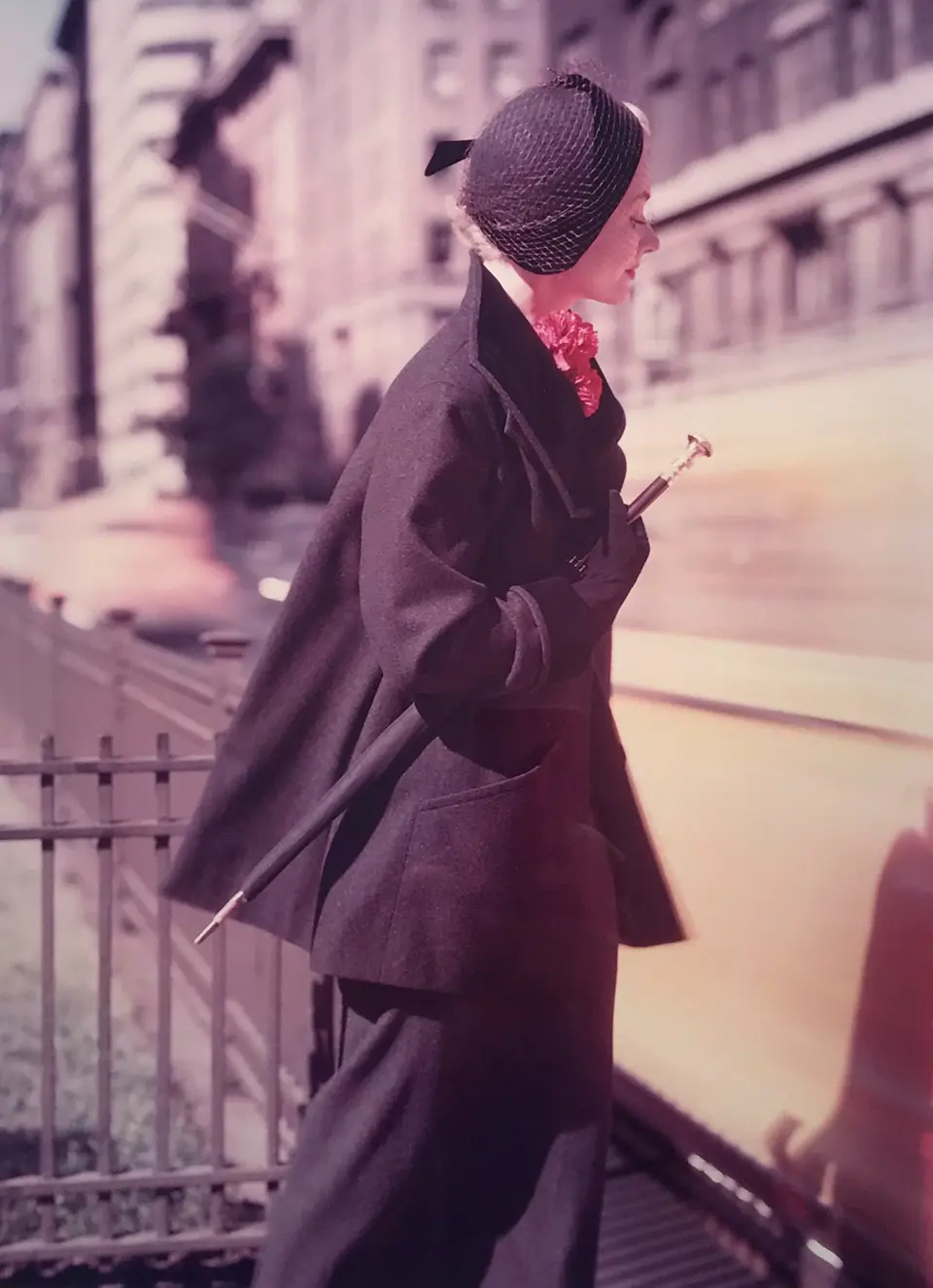 photo of lady wearing fashionable hat and coat with umbrella under her arm