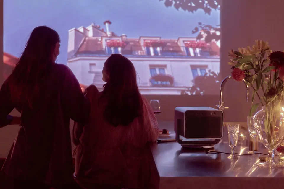 Two women watch a film