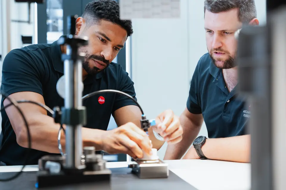 Two leica employees