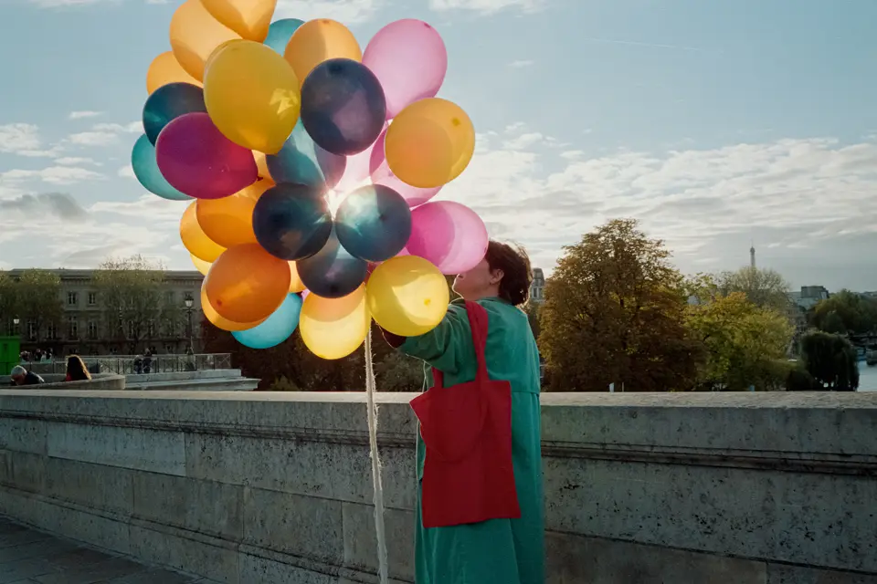 A person is holding balloons