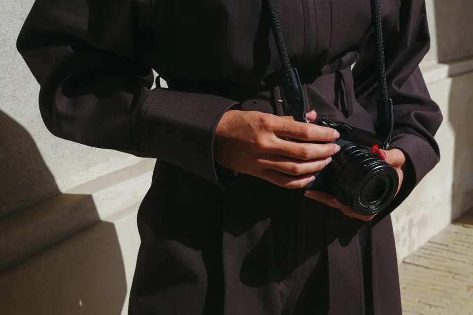 A woman is holding the Leica Q3 43
