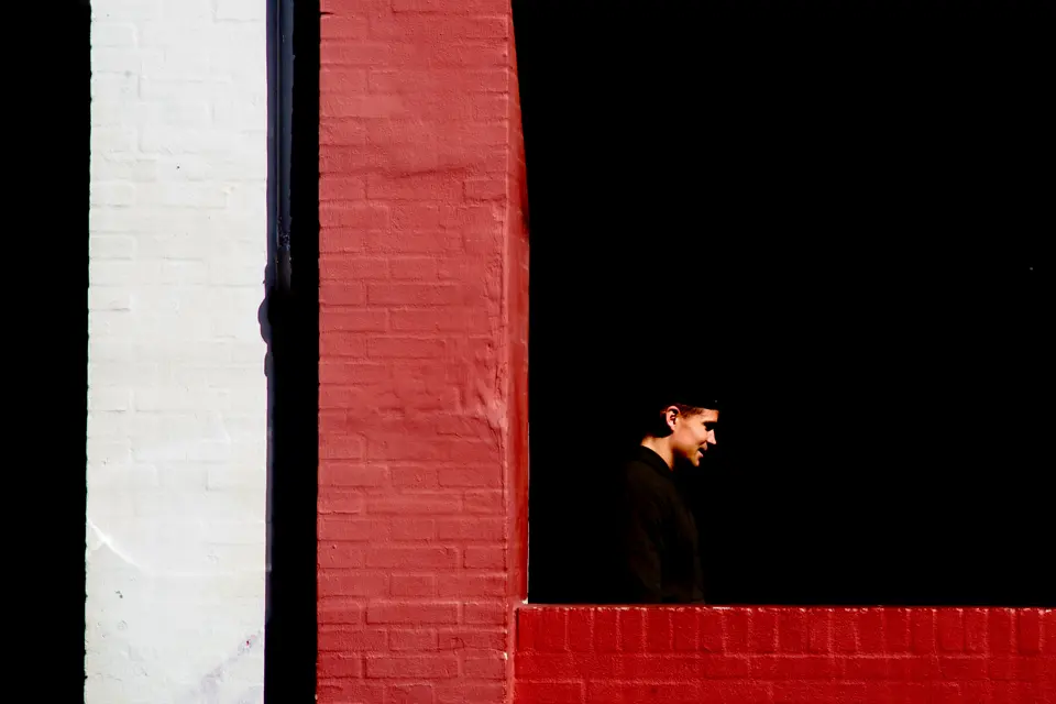 A man is standing in a window