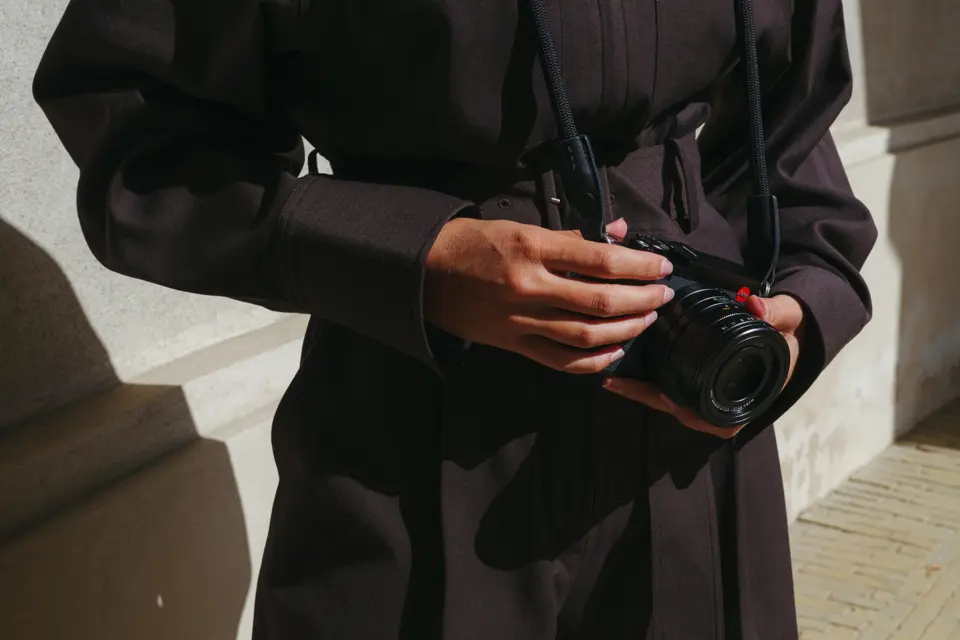 A woman is holding the Leica Q3 43