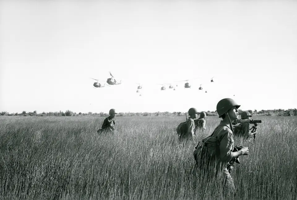 Soldiers and helicopters in the background