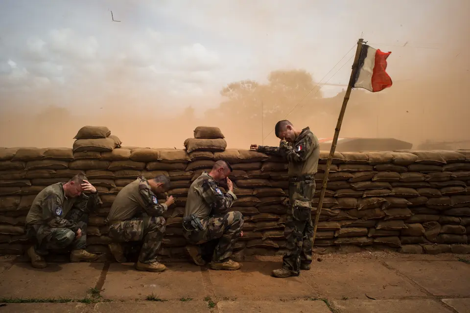 Weeping soldiers behind a wall