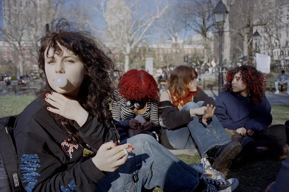 Teenage girl with chewing gum bubble