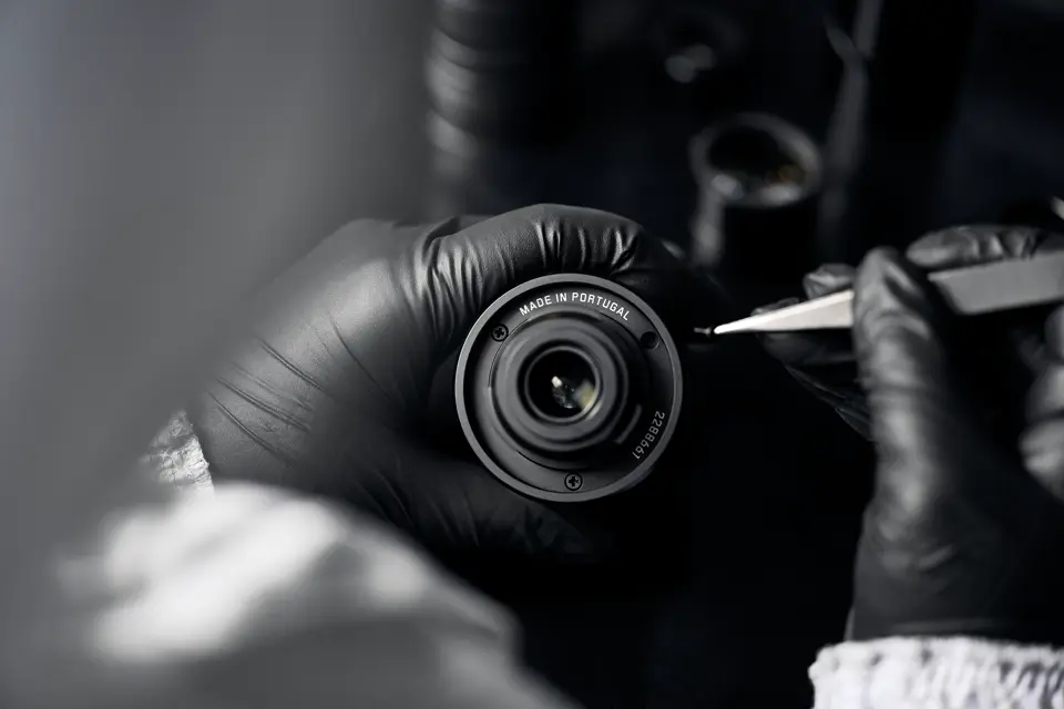 A Leica employee works on a Leica spotting scope