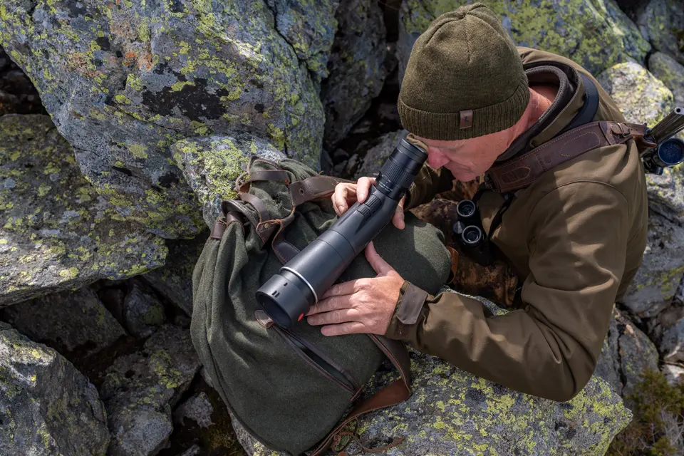 Man is looking through his APO-Televid spotting scope