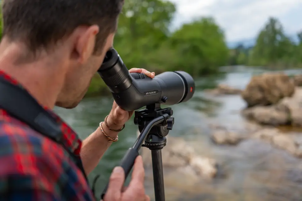Man is looking through his Leica APO-Televid spotting scope