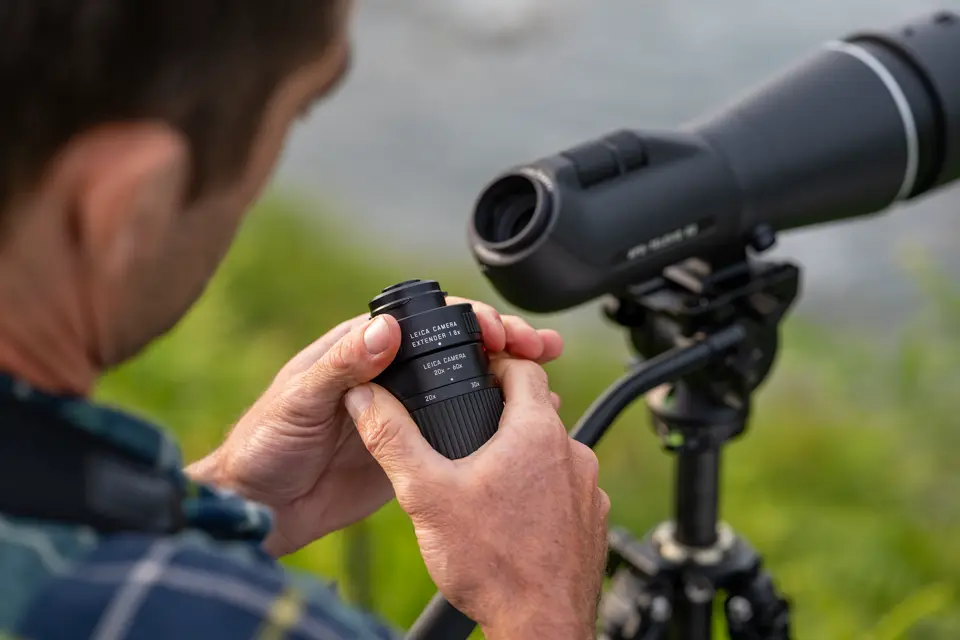 Man is assembling the eyepiece of his Leica APO-Televid spotting scope