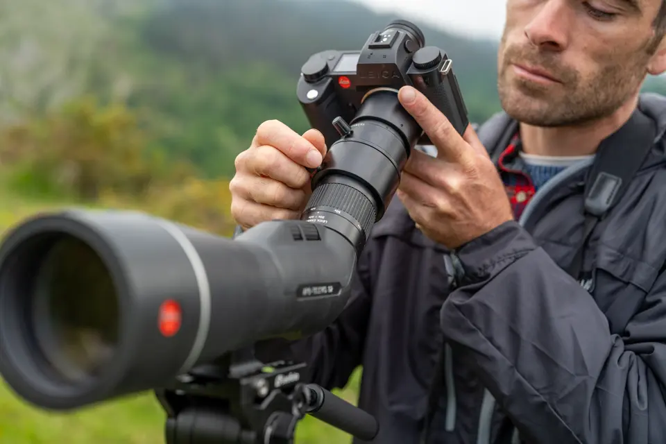 Man is digiscoping with his Leica APO-Televid spotting scope