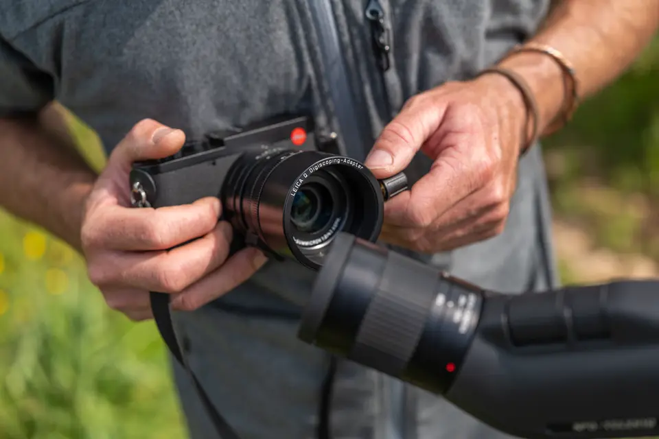 Man is digiscoping with his Leica APO-Televid spotting scope