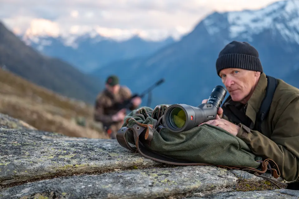 Man is looking through his Televid spotting scope