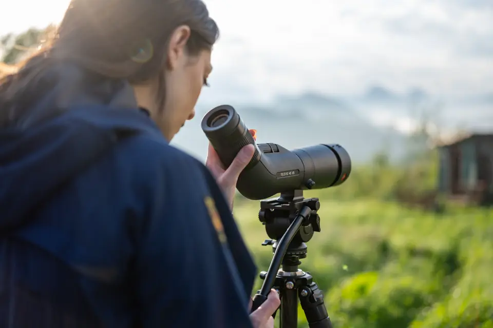 Woman is looking through her Leica Televid HD spotting scope