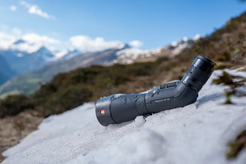 Leica Televid HD spotting scope is lying in the snow