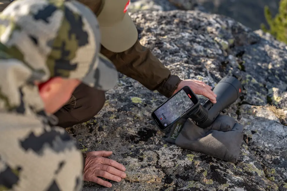Two people are digiscoping with the Leica Televid spotting scope