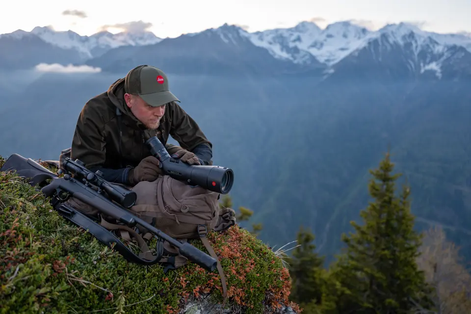 Man is looking through his Televid spotting scope