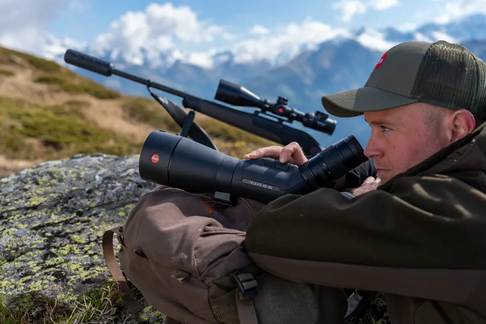 Man is looking through his Televid HD spotting scope