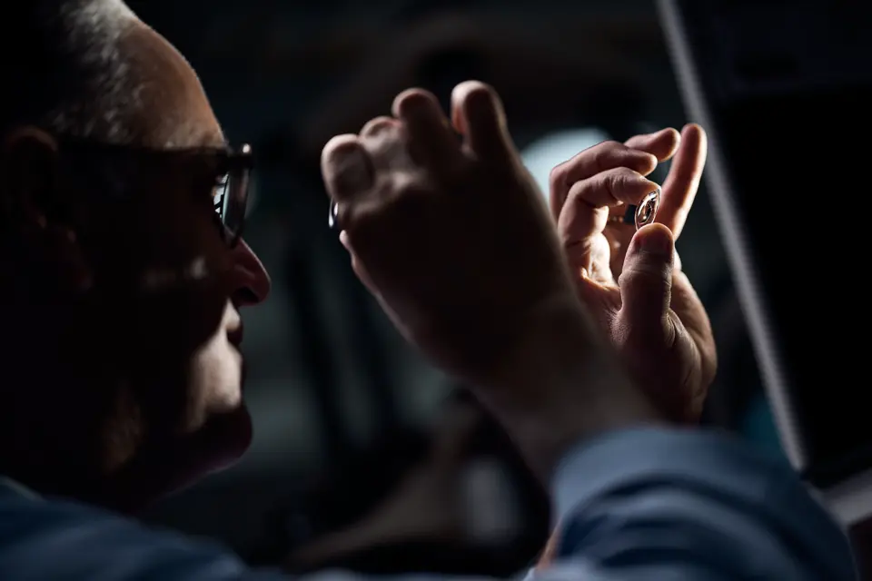 A Leica employee checks the lenses of a Leica spotting scope