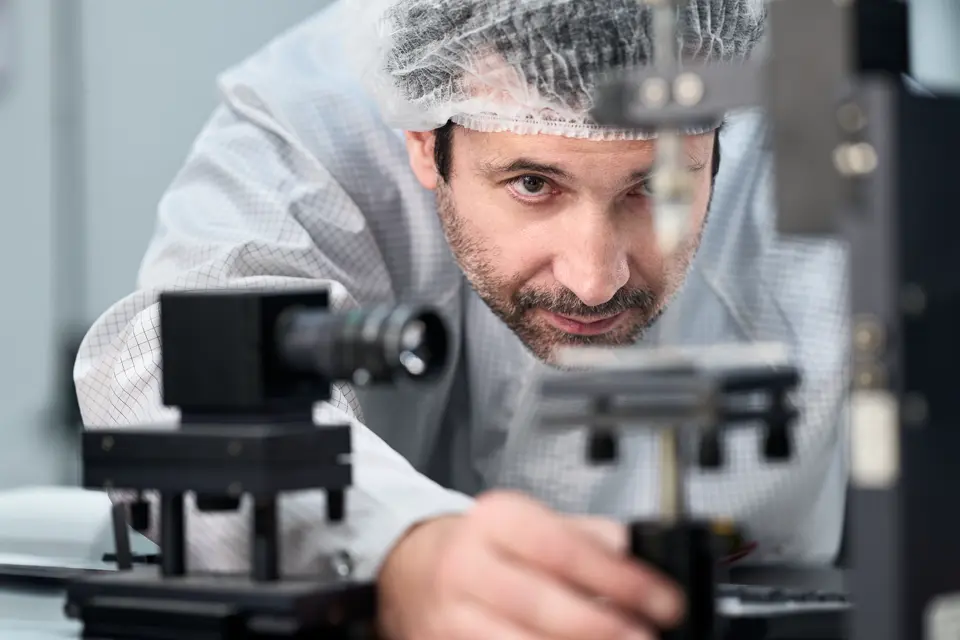 A Leica employee works on a Leica spotting scope