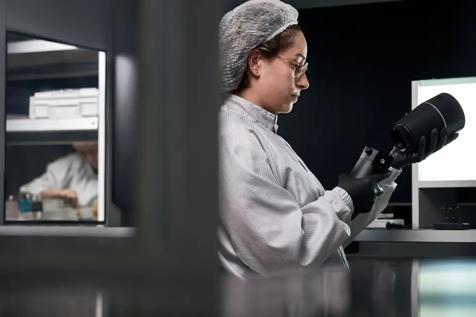 A Leica employee works on a Leica spotting scope