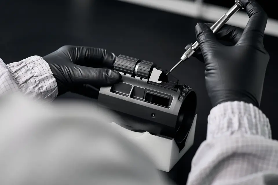 A Leica employee works on the dual fous of a Leica spotting scope