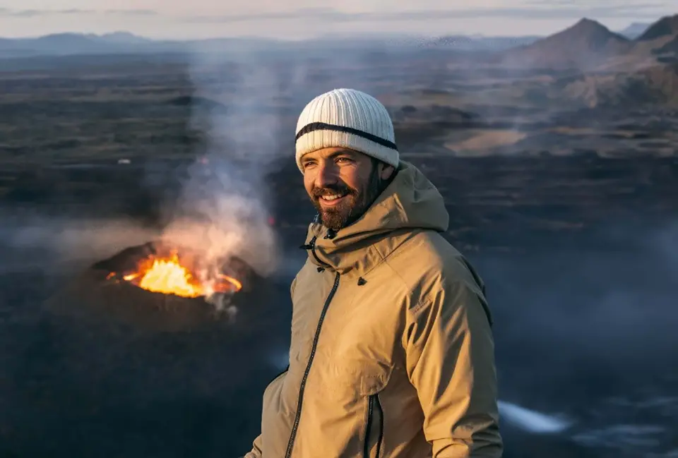 Image of Edwin Towler in front of a volcano and mountain range.