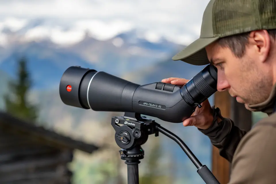 Man is looking through his Leica APO-Televid spotting scope