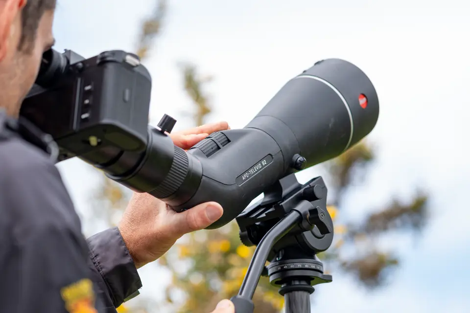 Man is digiscoping with his Leica Televid spotting scope