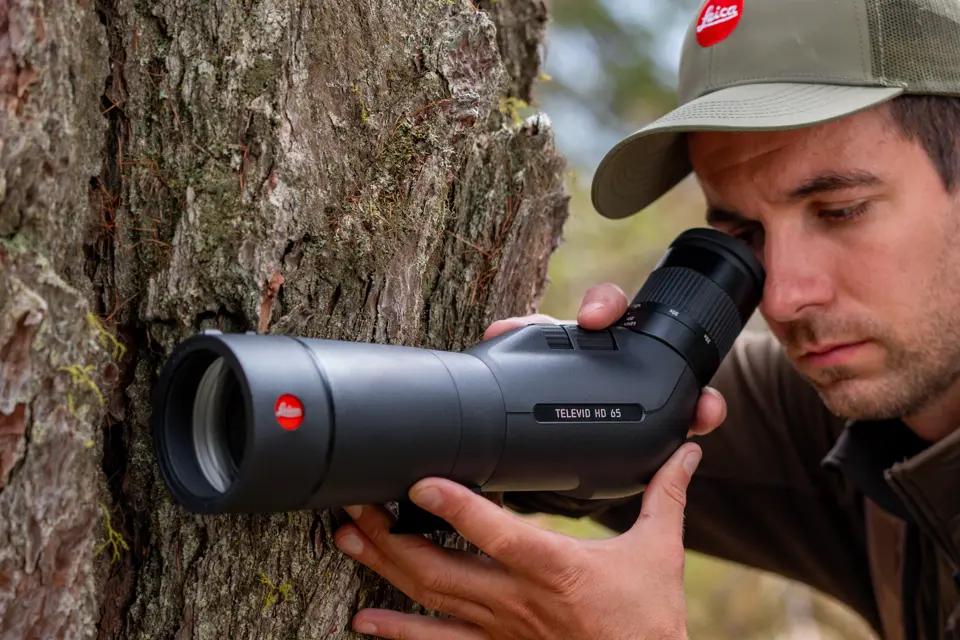 Man is looking through his Leica Televid HD spotting scope