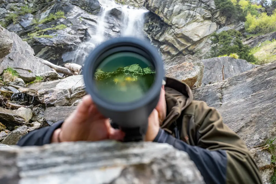 Man is looking through his Leica Televid HD