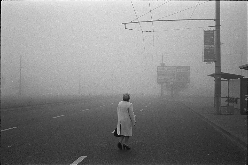 Black and White photograph of a person in a foggy street