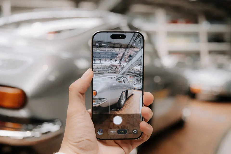A car is photographed with a smartphone.