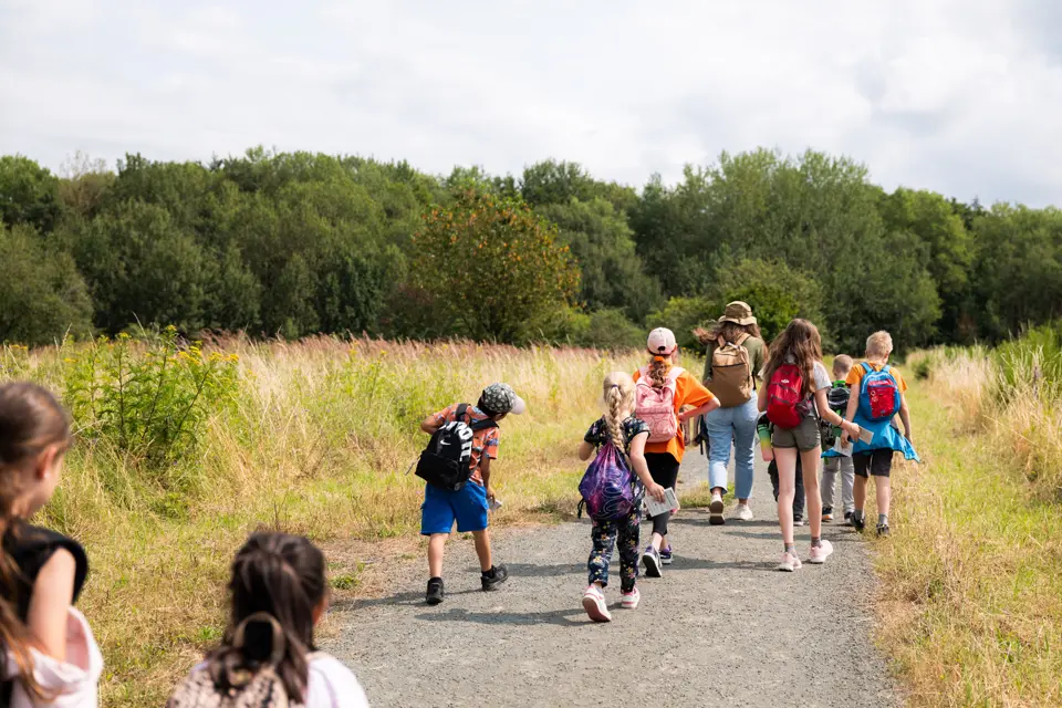 Children running along a country road.