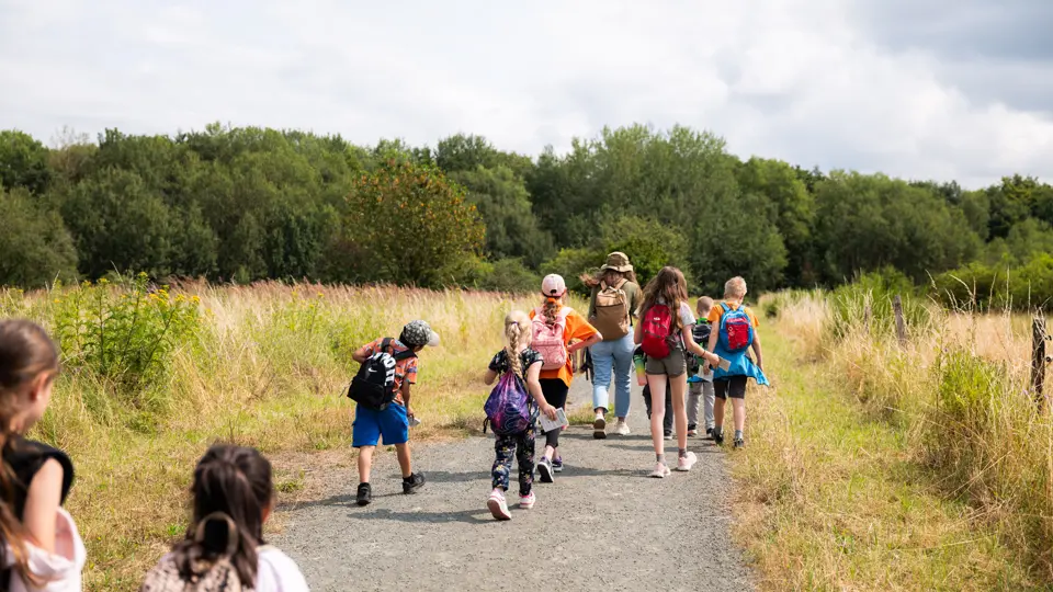 Children running along a country road.
