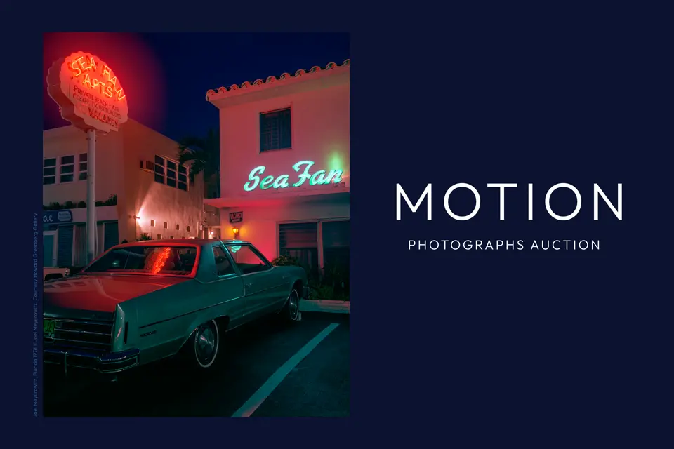 Old sports car in front of a hotel at night