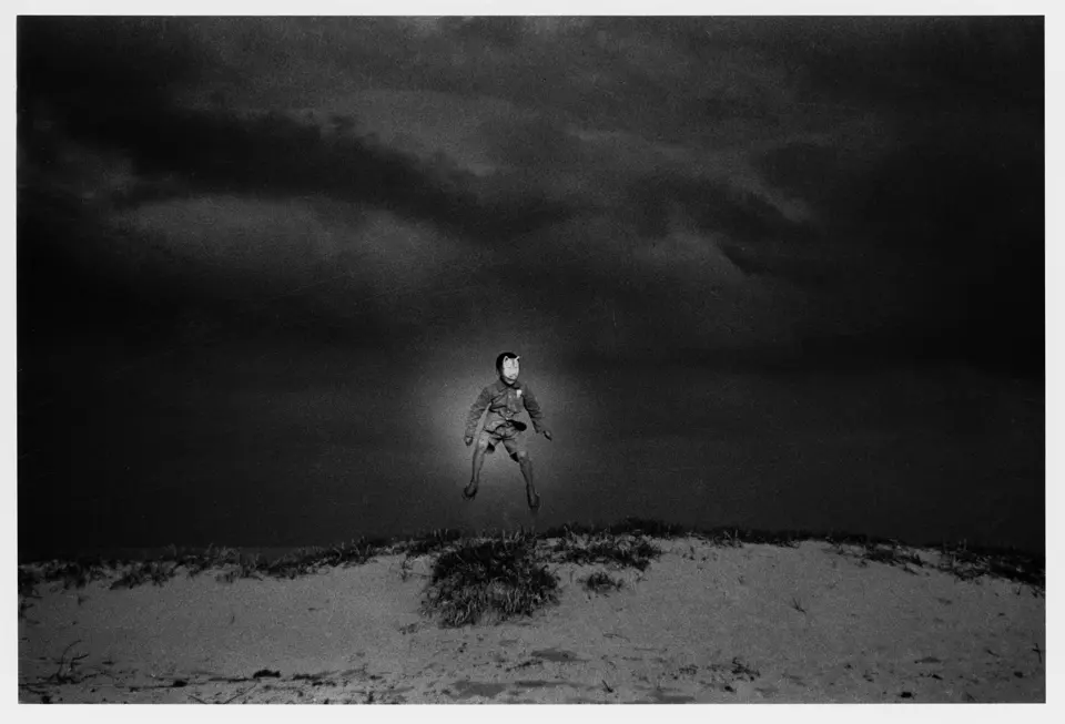 Man floating over sand