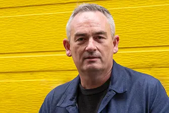 Jesse Marlow infront of a Yellow wall