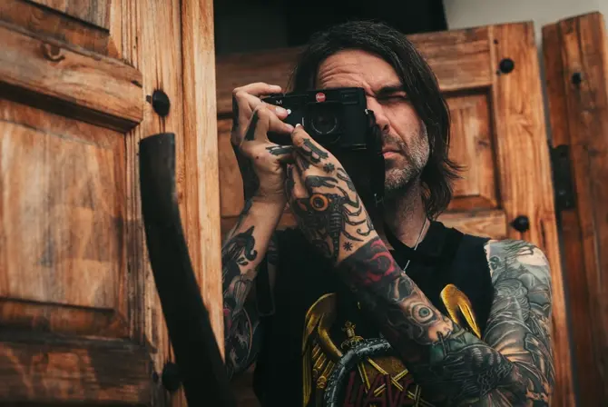 Ben Alexis is taking a photograph with the Leica M