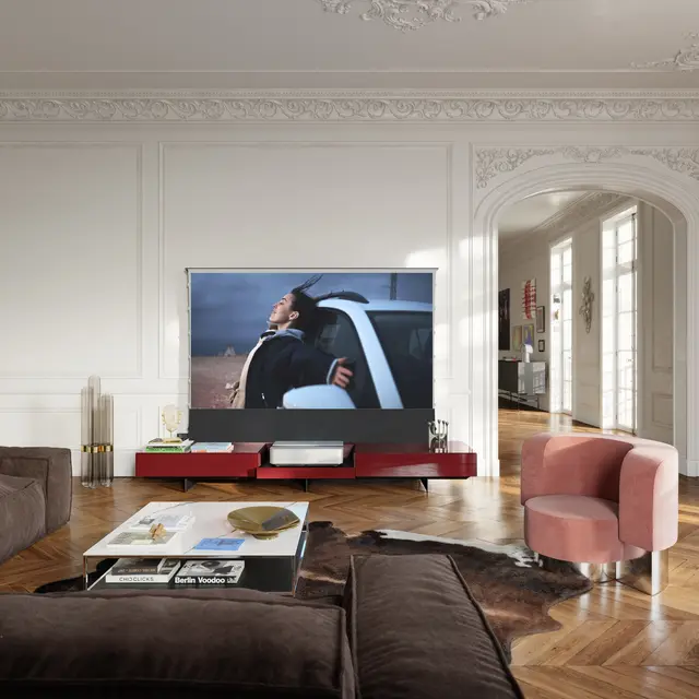 Leica Cine 1 on TV furniture in a living room.