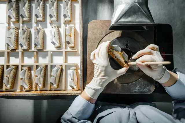 A worker making parts for the Leica binoculars
