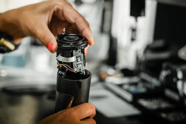 An employee working on the Leica binoculars