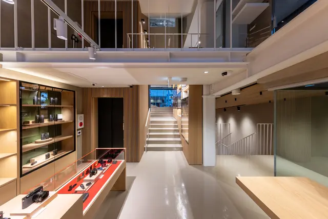 Product shelfs and stairs that lead upstairs inside Leica Store Tokyo Omotesando. 