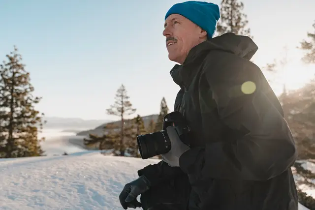 Portrait of Dean Blotto Gray photographing in the snow.